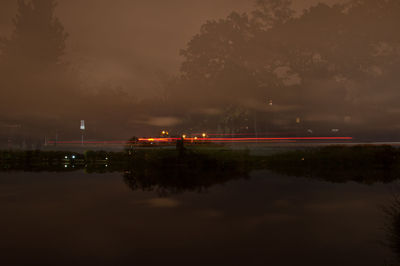 Reflection of trees in water at night