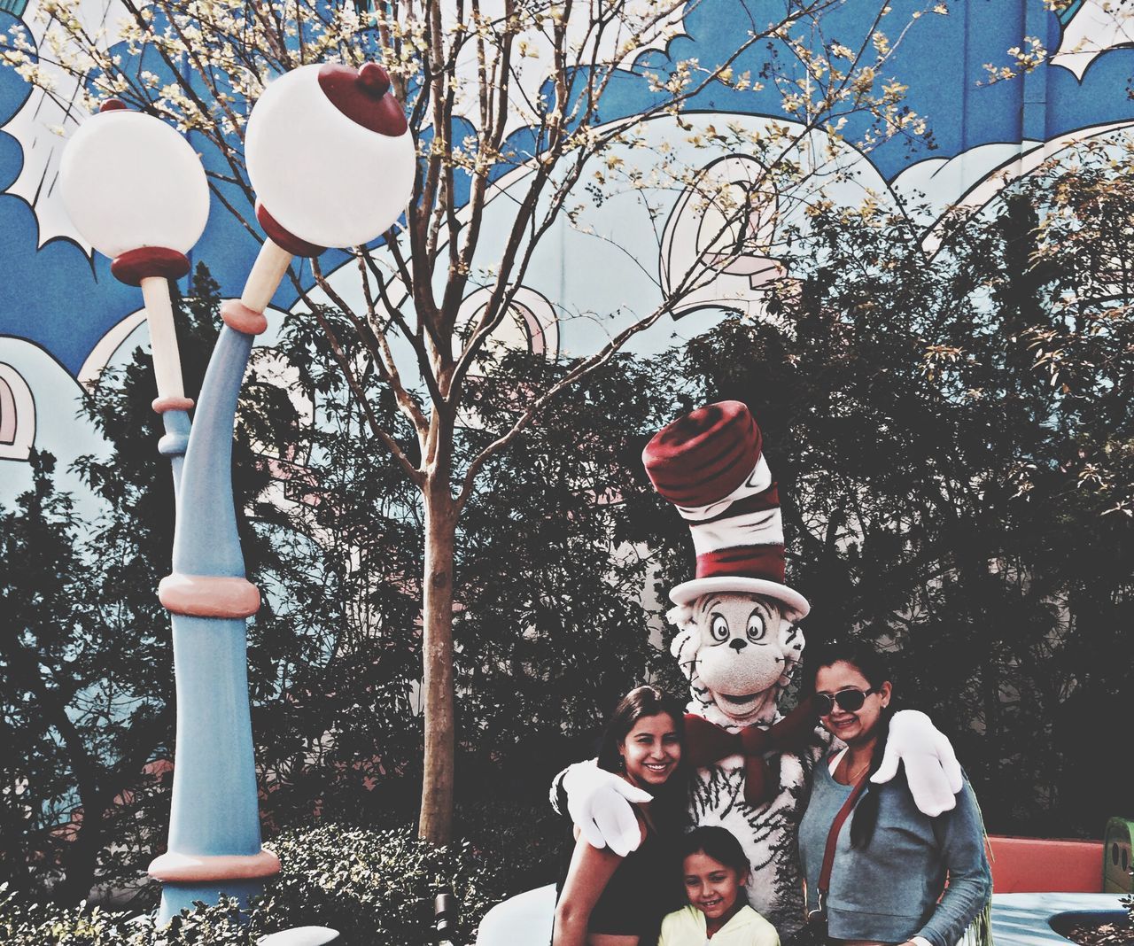 hanging, tree, decoration, red, celebration, lighting equipment, balloon, lantern, childhood, low angle view, leisure activity, day, lifestyles, outdoors, tradition, street light, cultures, sky