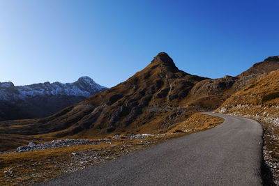 Scenic view of mountains against clear blue sky