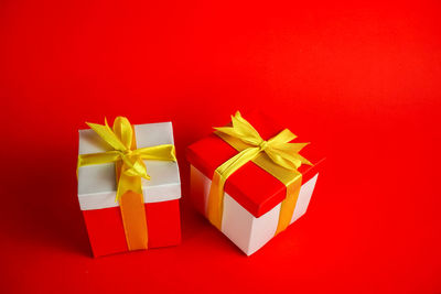 Multi colored umbrellas in box against red background