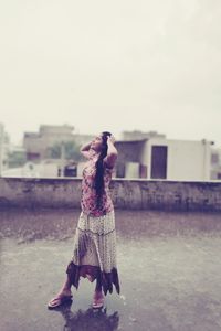 Full length of woman standing in front of building