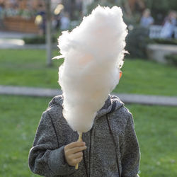 Boy holding cotton candy in park