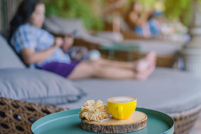 Rear view of people sitting on table at home