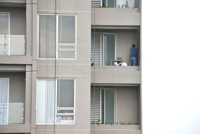 Man on window of building