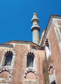 Low angle view of historic building against blue sky