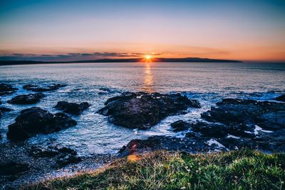 Scenic view of sea against sky at sunset