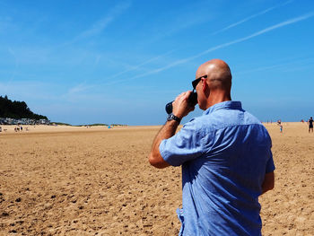 Man standing on beach against sky