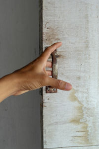 Close-up of hand touching wall