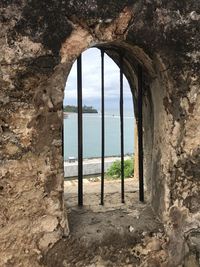 Ocean view through a barred window at fort jesus mombasa kenya