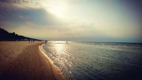 Scenic view of beach against sky during sunset