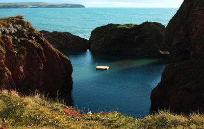 Scenic view of sea by cliff