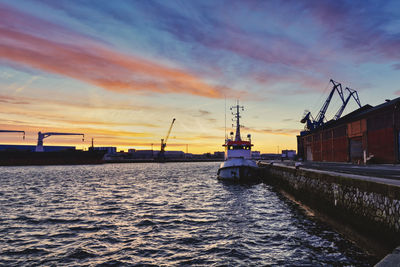 Boats sailing on sea against sky during sunset