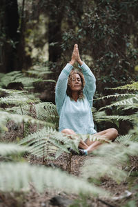 Rear view of woman standing in forest