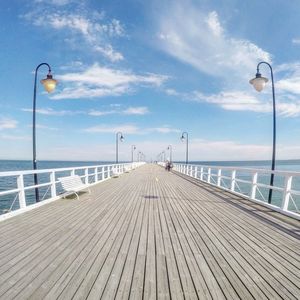 Scenic view of jetty against cloudy sky