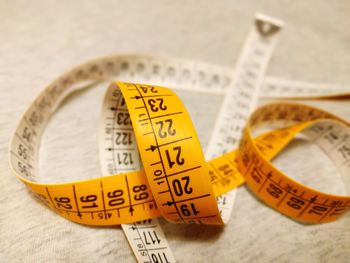 High angle view of tape measure on wooden table