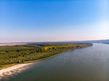 Scenic view of lake against clear blue sky