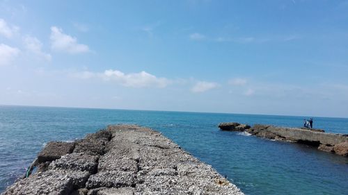 Scenic view of sea against blue sky