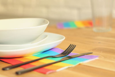 Preparing diner table during pride month. using lgbt's flag colored napkins.