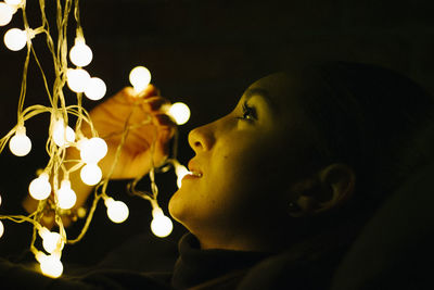 Close-up portrait of young woman looking away