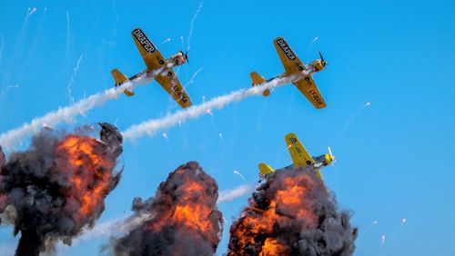 Low angle view of airshow against sky