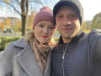 Portrait of smiling young couple in park during winter