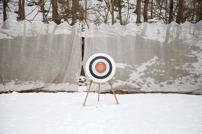 Dartboard on snow covered field