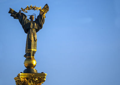 Statue of berehynia against clear blue sky