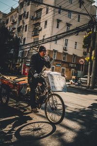 Man cycling on bicycle in city