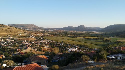 High angle view of houses and buildings against clear sky