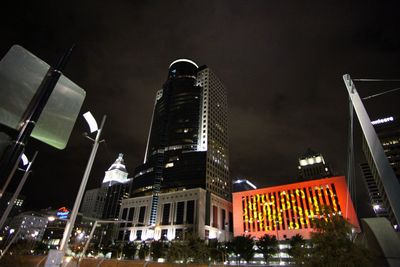 Low angle view of illuminated skyscrapers against sky at night