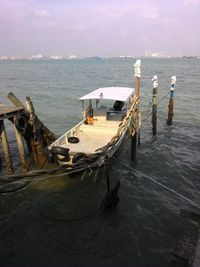 Boats moored on sea against sky