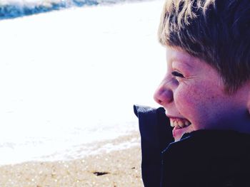 Close-up of boy smiling on beach