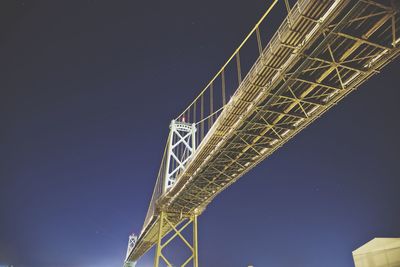 Low angle view of lions gate bridge against sky at dusk