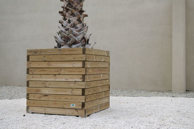 Stack of firewood in basket on wall