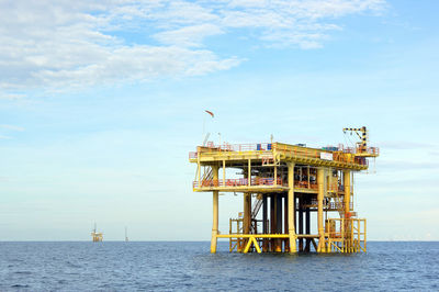 Lifeguard hut in sea against sky