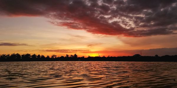 Scenic view of dramatic sky over sea during sunset