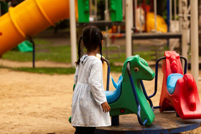 Side view of cute girl playing at playground