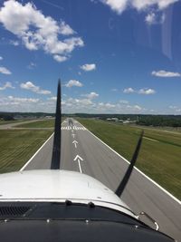 Close-up of airplane on runway against sky