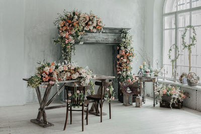 Stylish bright interior of the living room, decorated for easter. fireplace with flowers.