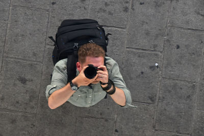 High angle view of man photographing outdoors