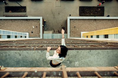 High angle view of woman standing by railing