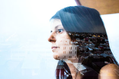 Close-up of girl over city