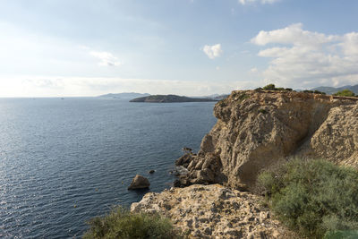 Scenic view of sea and mountains against sky