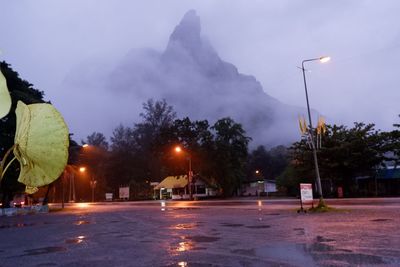 Illuminated street lights in city at night