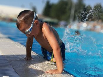 Full length of shirtless boy in swimming pool