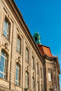 Low angle view of old building against blue sky