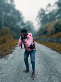 Full length of man photographing on camera