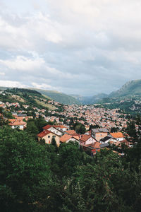 High angle view of houses in town against sky