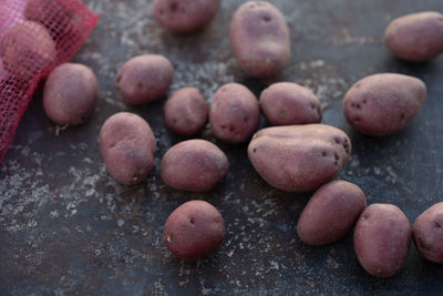 Red mesh produce sack of baby red potatoes