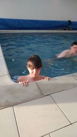 High angle portrait of shirtless boy in swimming pool